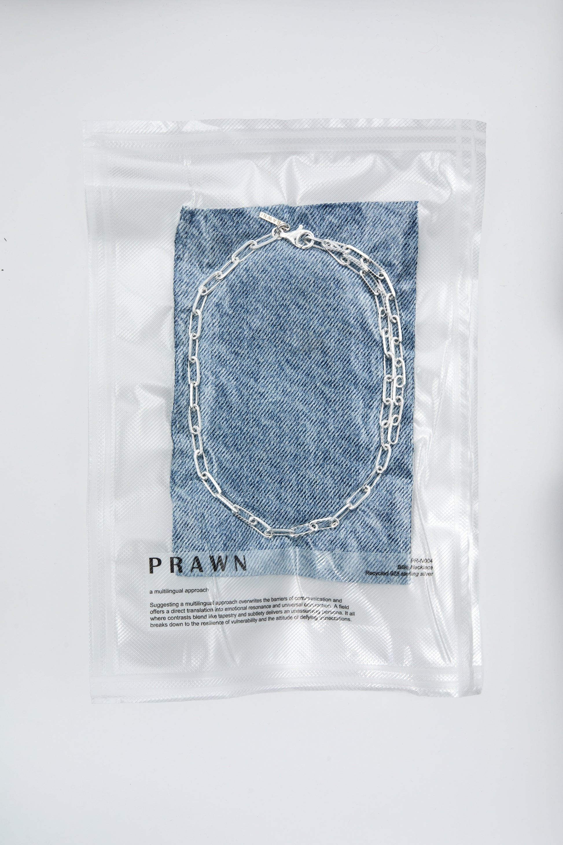 Chunky silver necklace in vacuum packaging from the jewellery brand PRAWN.