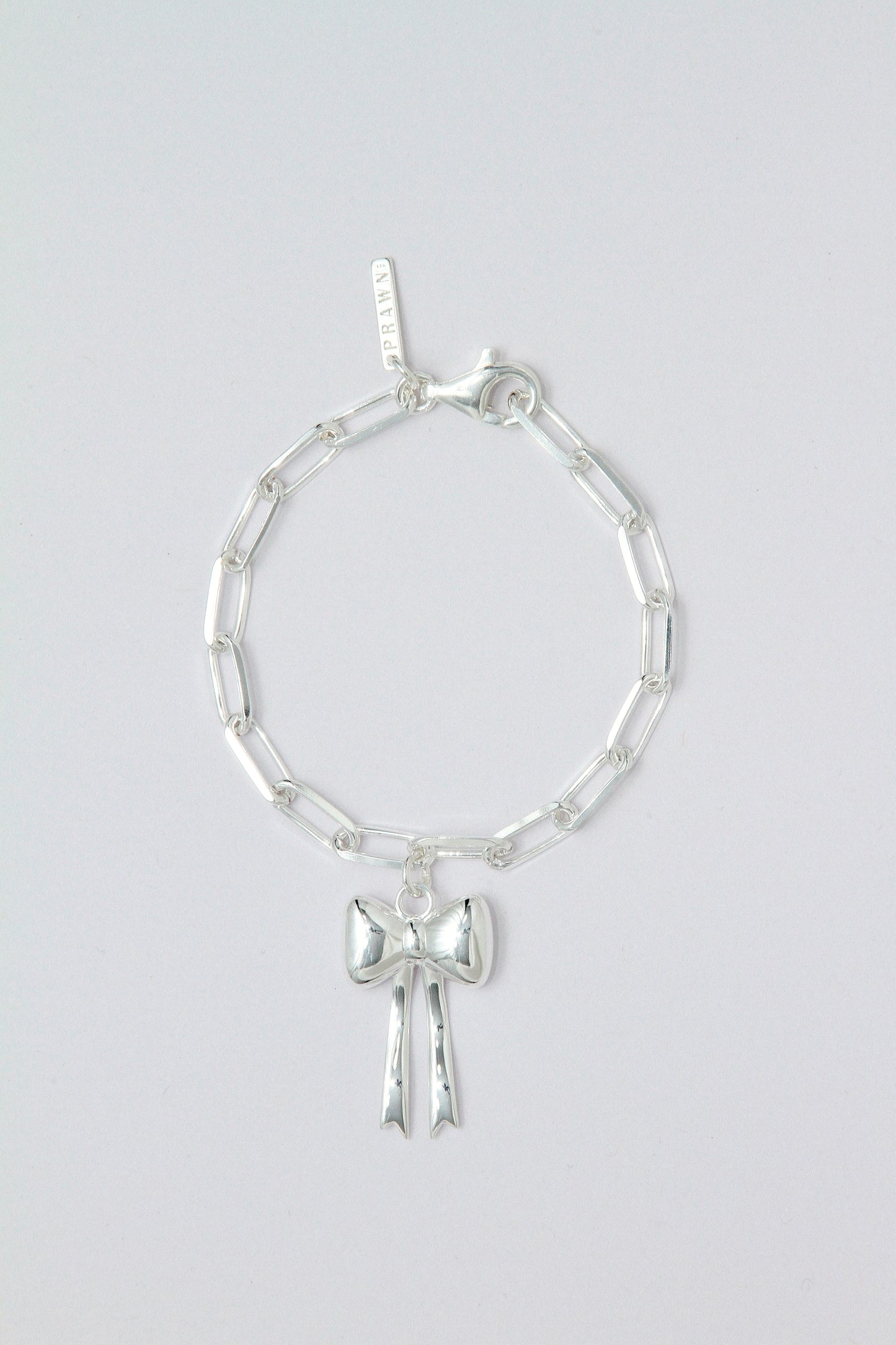 Silver bracelet with a bow charm