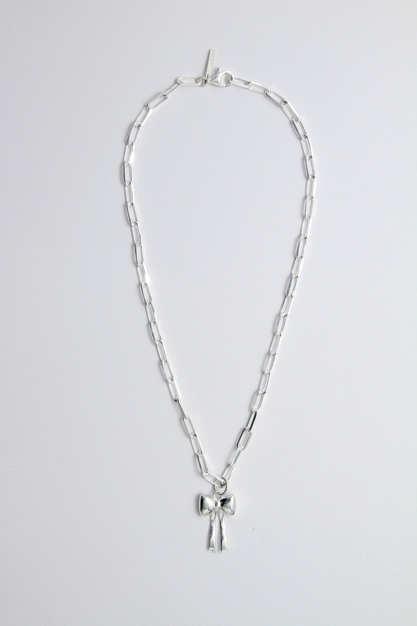 Silver necklace with a bow pendant