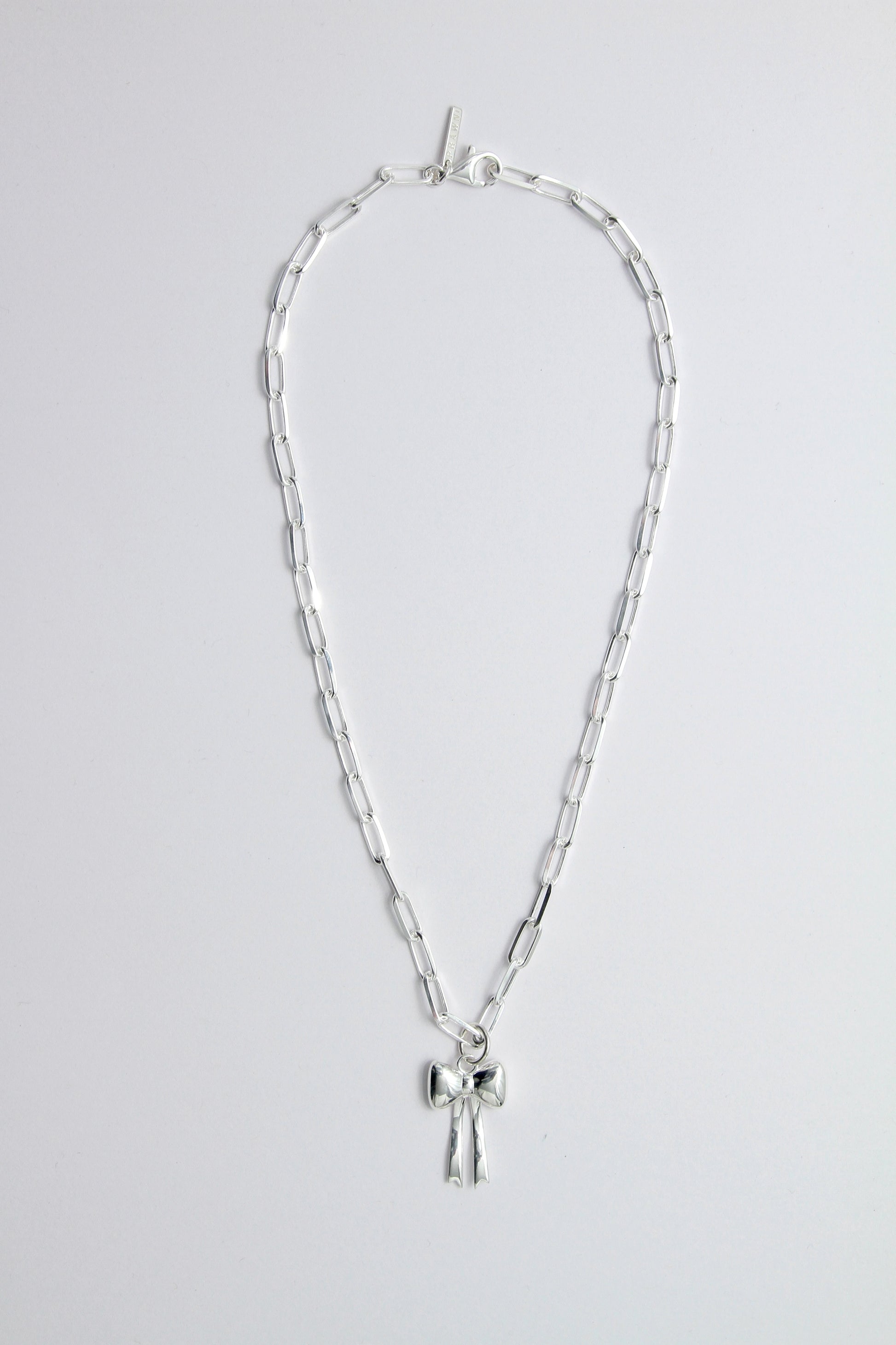Silver necklace with a bow pendant