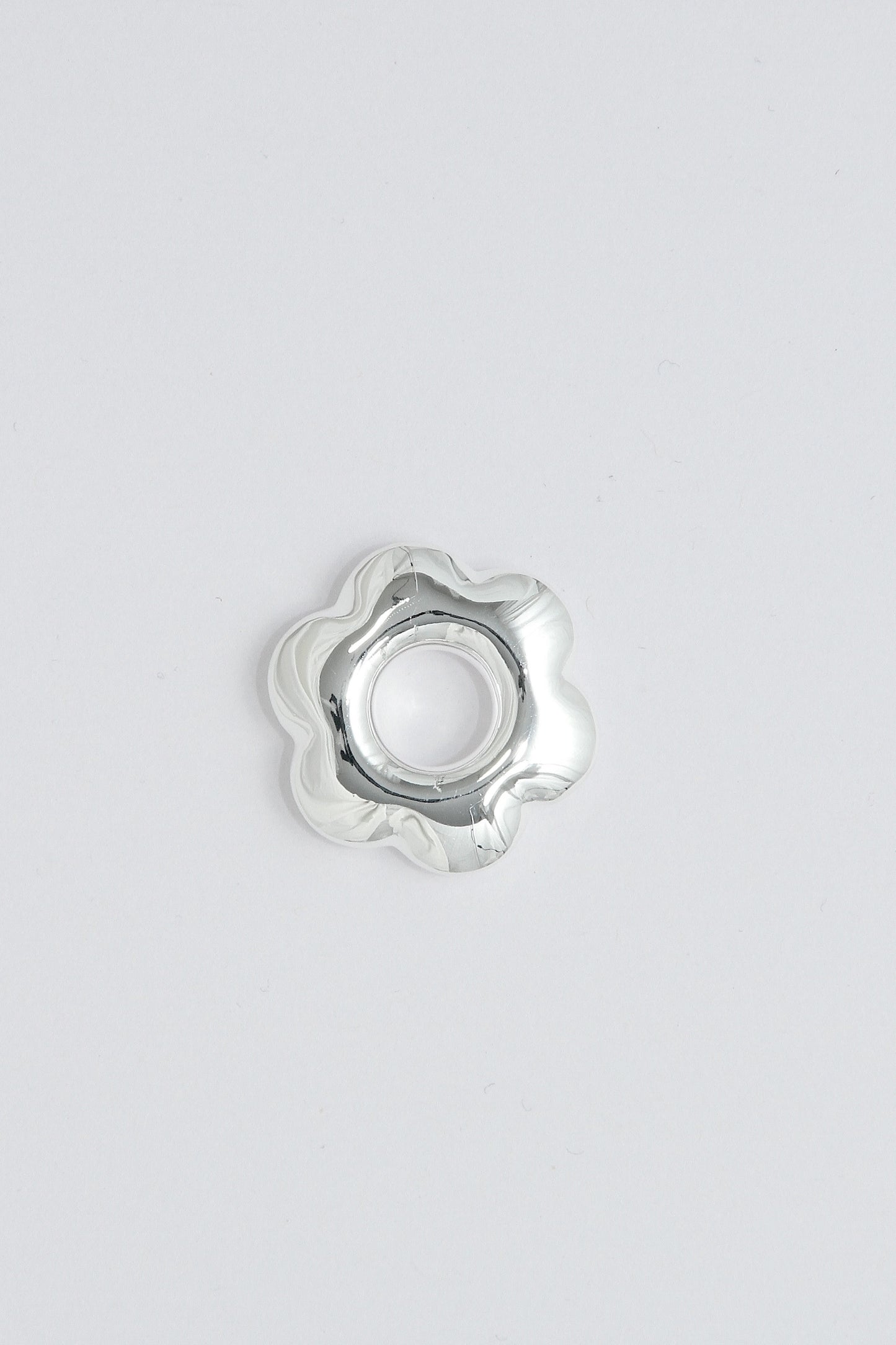 Puffy silver flower pendant