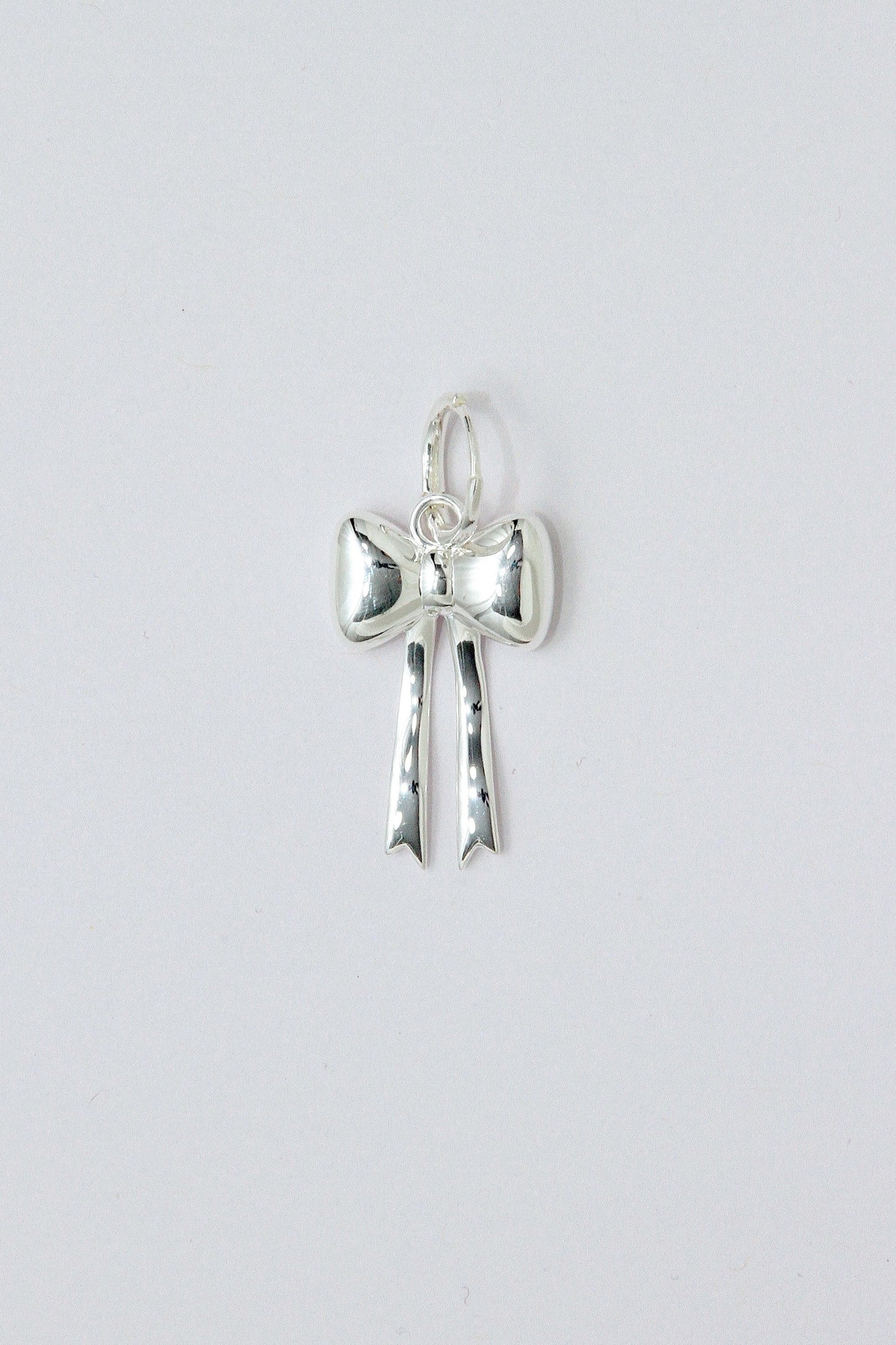 Silver bow pendant